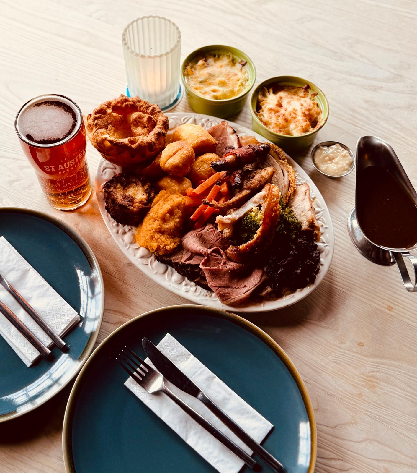 A generous Sunday roast with carved meats, Yorkshire pudding, roast potatoes and vegetables at Who'd Have Thought It