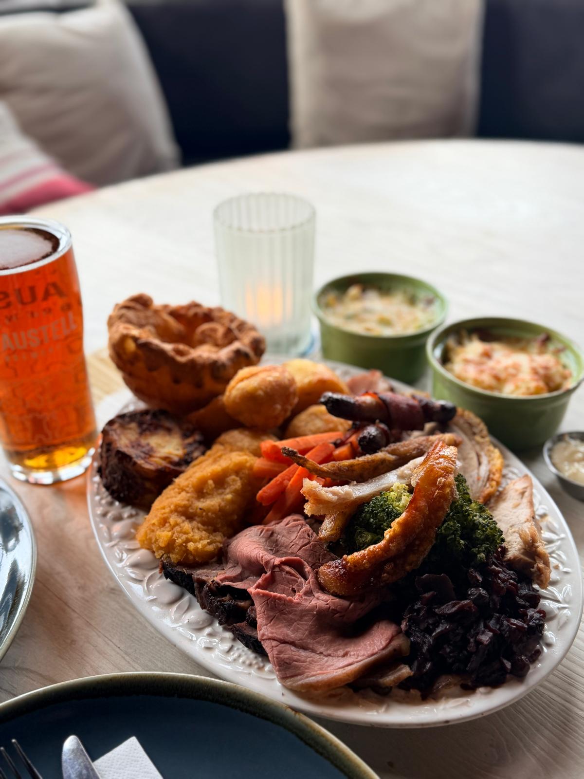Sunday roast with carved meats, Yorkshire pudding, roast potatoes and vegetables