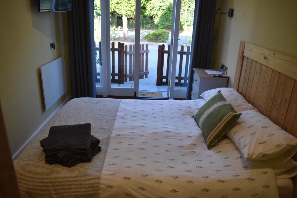The Tamar pod, with a double bed, TV and doors looking out to the trees